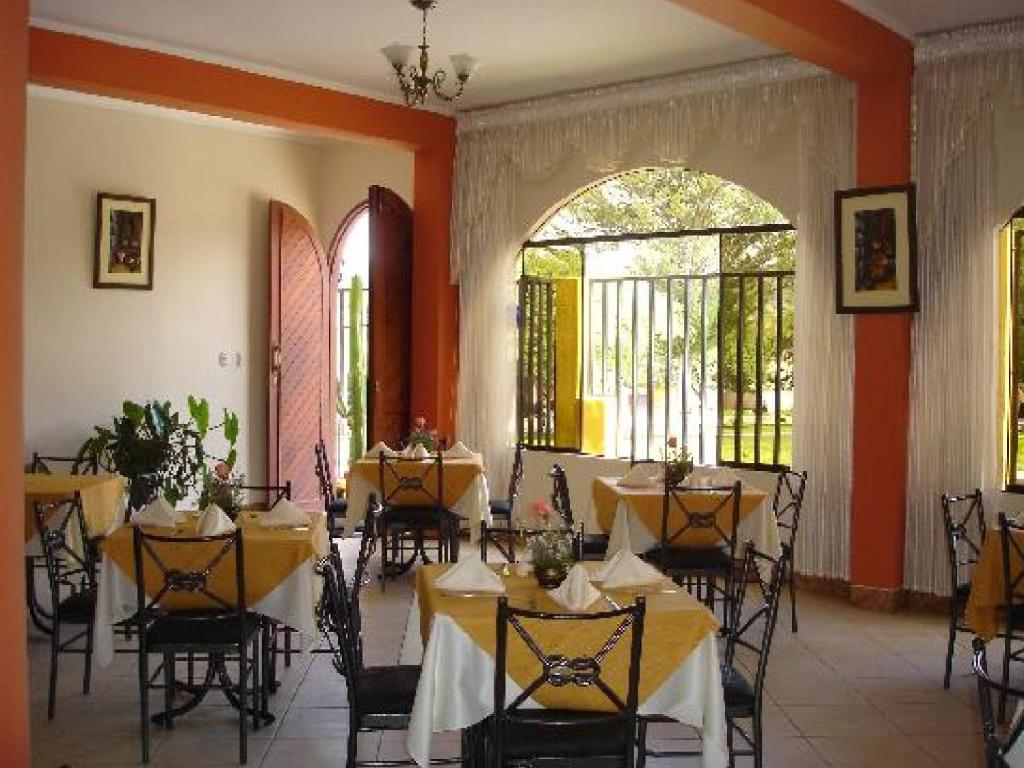 阿亚库乔赛拉利昂多拉达酒店的用餐室配有桌椅和黄色桌布