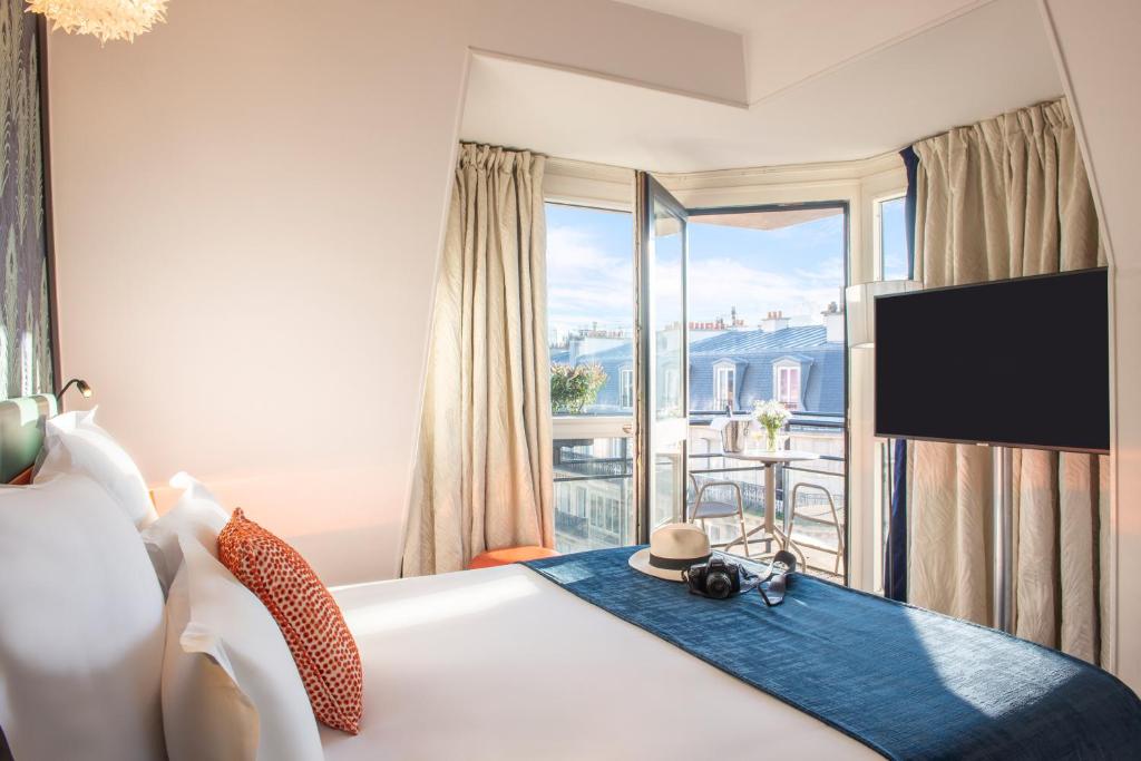 巴黎艾菲尔叶琳酒店 的一间卧室设有一张床,享有阳台的景色