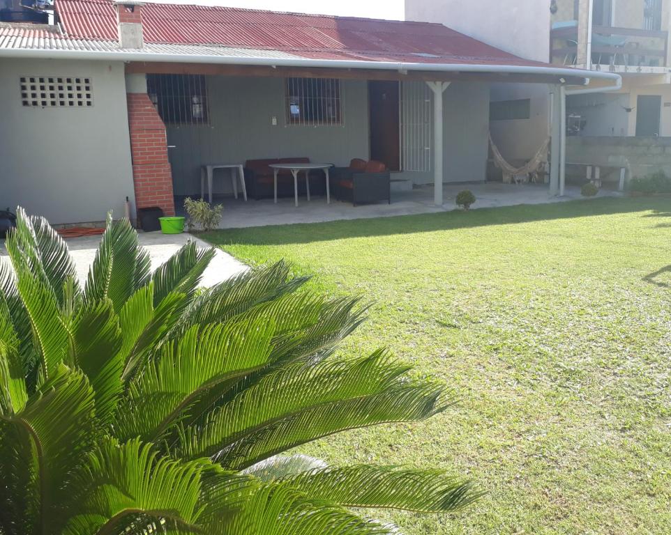 加罗帕巴Casa na Garopaba com Varanda的前面有绿色植物的房子