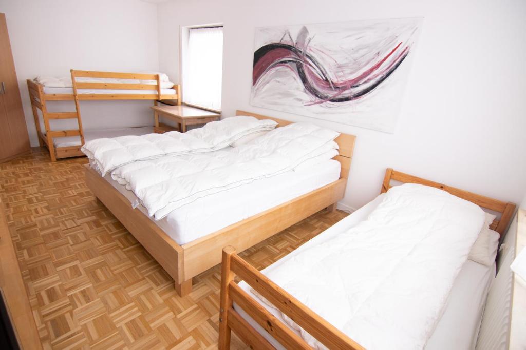 诺伊马克特Familienzimmer的一间设有两张床的客房,墙上挂着一幅画