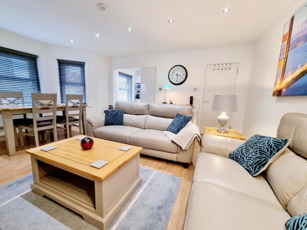 伯恩茅斯Bournemouth Luxury Apartment的客厅配有白色家具和桌子