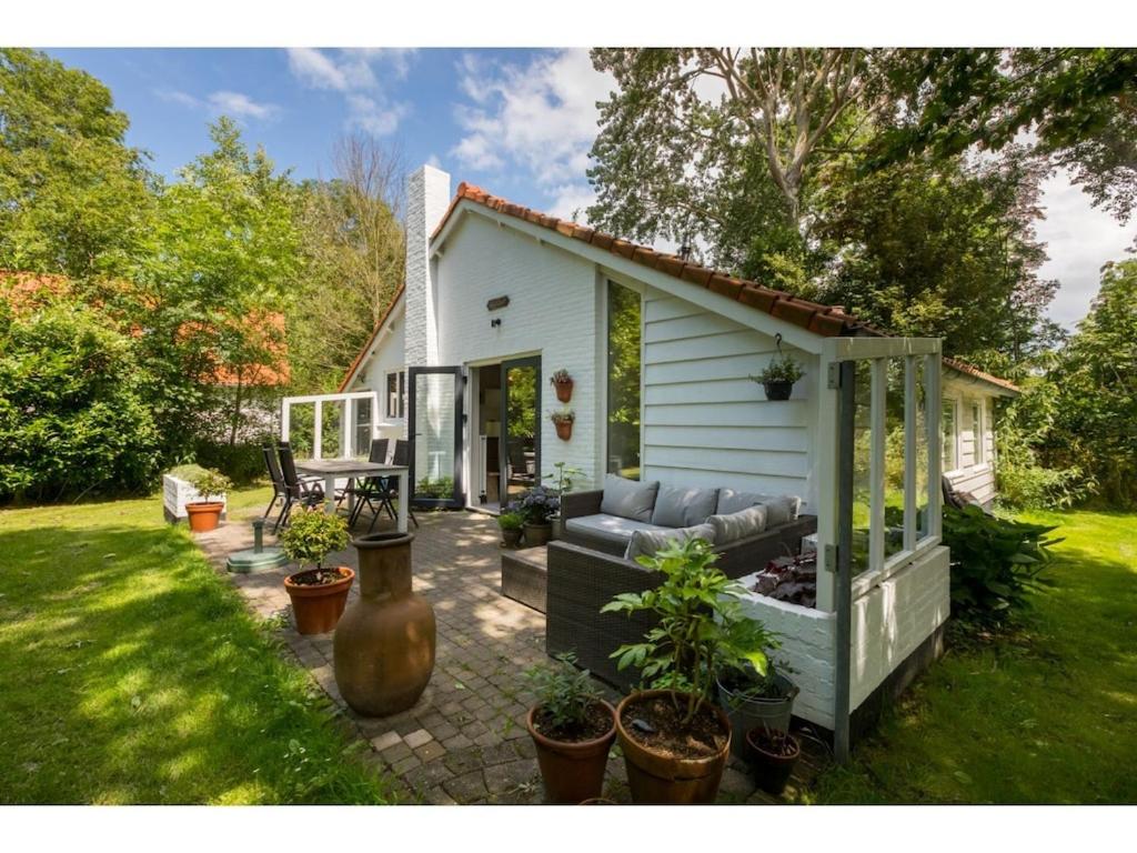迪斯胡克Tranquil holiday home in Dishoek with garden的一座小白色房子,在院子里配有沙发