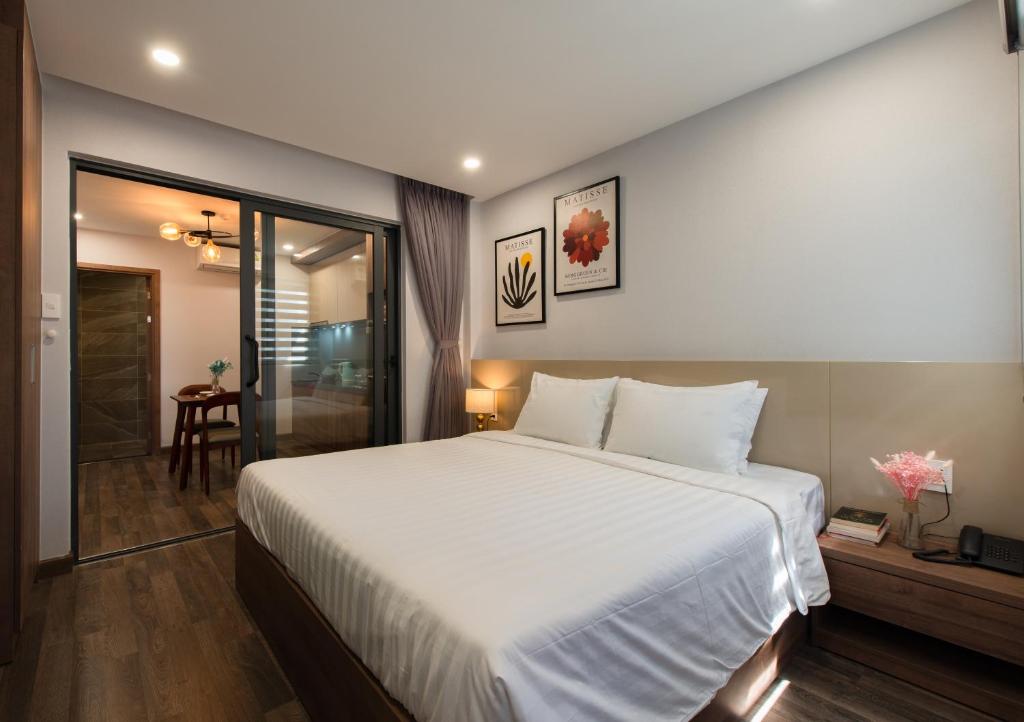 芽庄The Anchor Apartment - Nha Trang的一间带白色大床的卧室和一间浴室