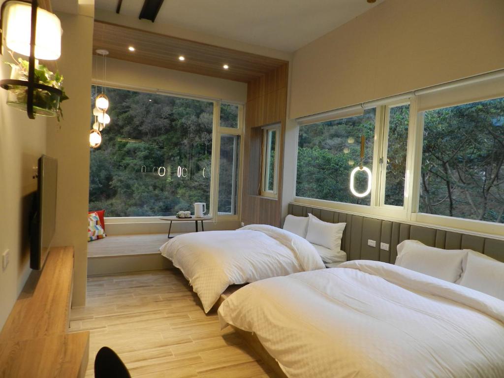 和平区谷關明高溫泉 Mingao Hot Spring Resort的带2扇窗户的客房内的2张床
