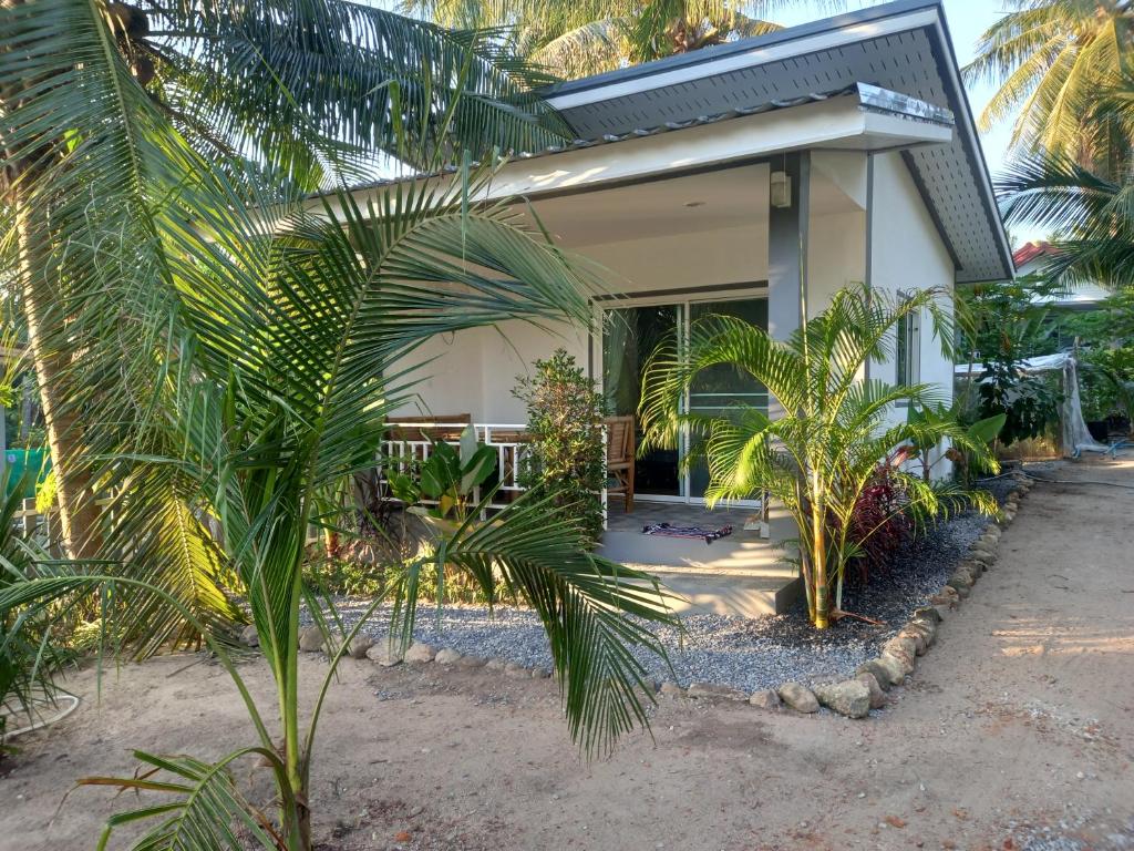 西塔努bungalow independant的前面有棕榈树的房子