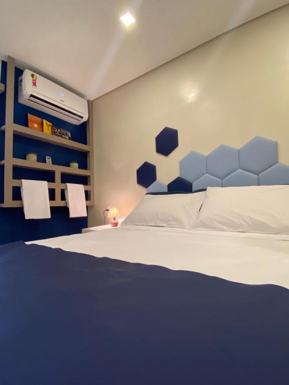 圣保罗URBAN BOX HOUSE的一间卧室配有一张蓝色床头板的床