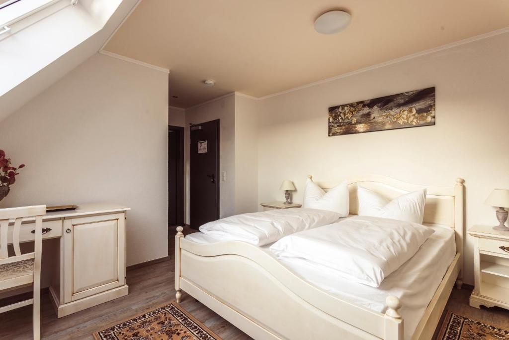 莱茵河畔凯尔Hotel Roma的白色的卧室配有白色的床和一张桌子