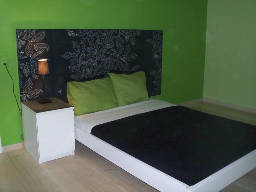 圣乔治斯Maria's Studios的一间卧室配有一张带黑色和绿色墙壁的床。