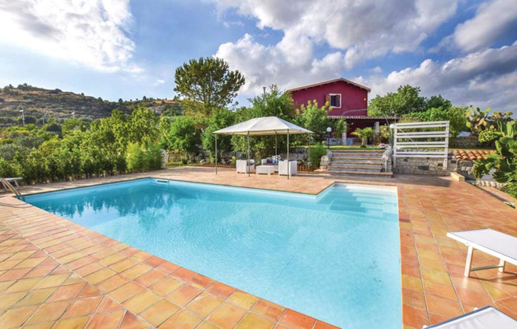 GiarratanaCeretanum Holiday House的一座带房子的庭院内的游泳池