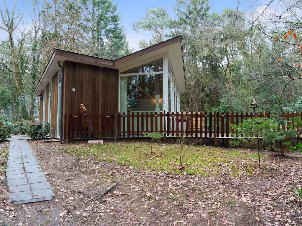诺格Idyllically located Holiday Home in Norg with Sauna的院子中带木栅栏的小房子