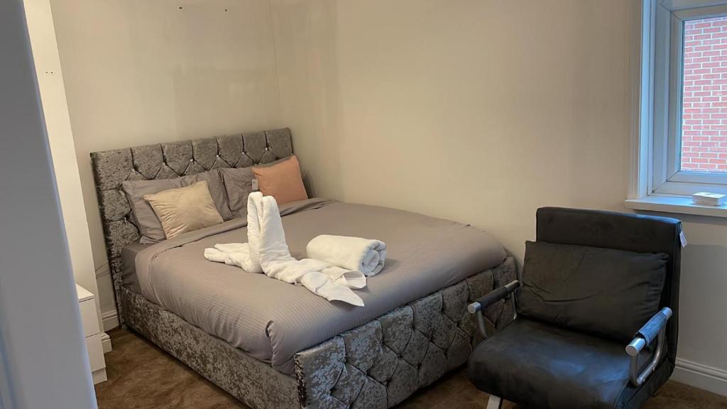 南安普敦Alder en-suite self catering with private shower 3的椅子间里一张带毛巾的床