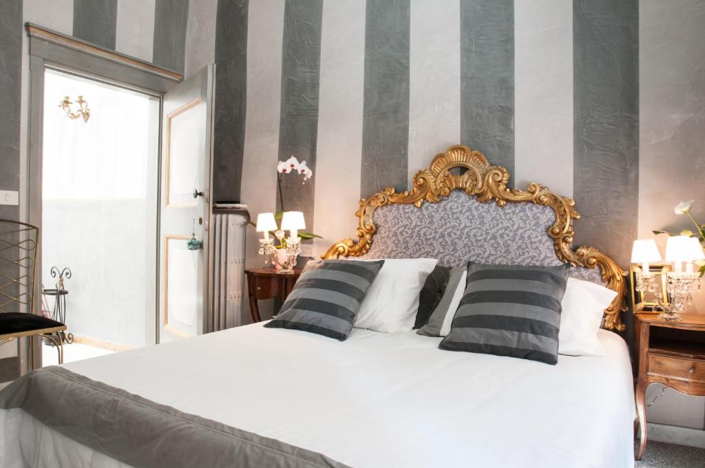 阿雷佐BIBI BOUTIQUE AREZZO Cartazucchero - Cioccolato的卧室配有白色的床和黑白色枕头