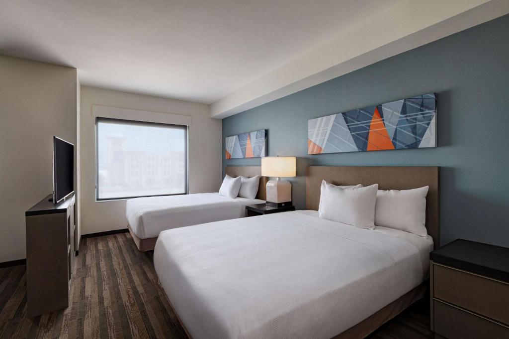 卡尔斯巴德Hyatt House Carlsbad的酒店客房设有两张床和电视。