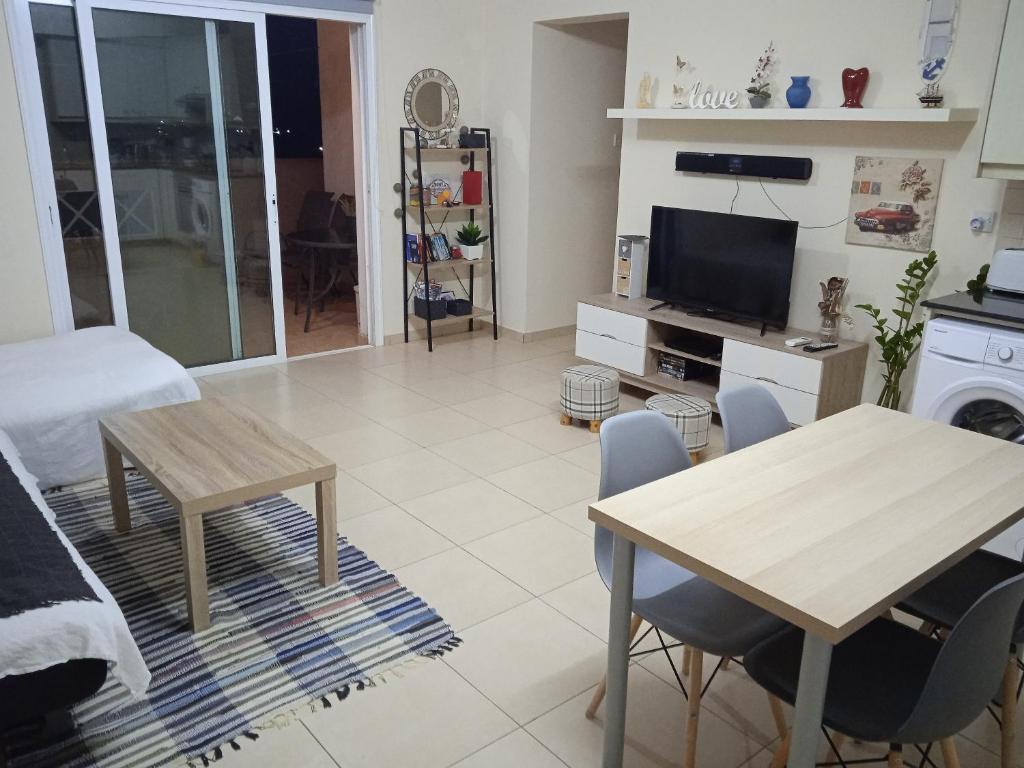 XylophaghouXylophagou Larnaca Ayia Napa 1 bedroom apartment的客厅配有桌子和电视