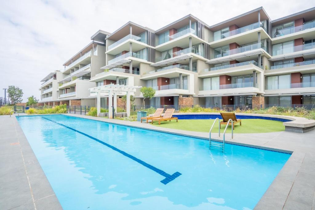 SibayaUnit 215 Oceandune - Stunning & Modern Apartment的大楼前的游泳池