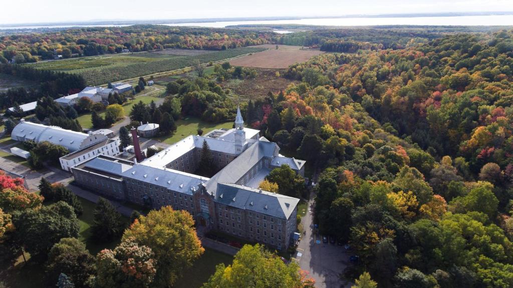 OkaAuberge de l'Abbaye d'Oka的森林中央建筑物的空中景观