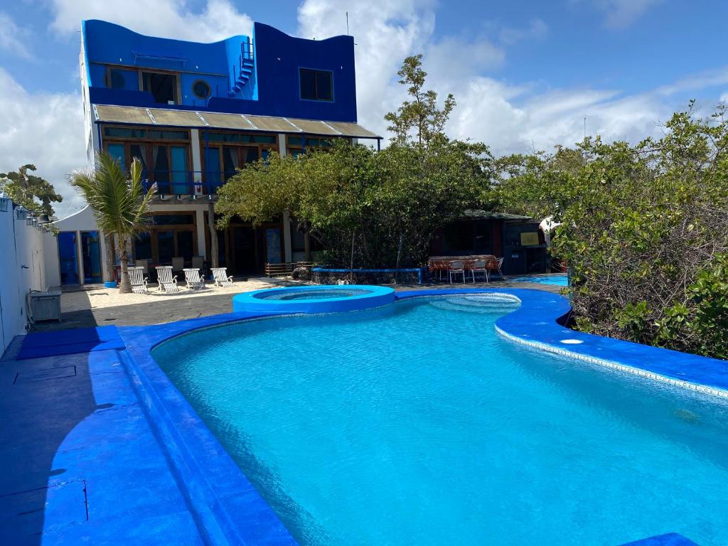 阿约拉港海湾之家乡村别墅的大楼前的蓝色海水游泳池