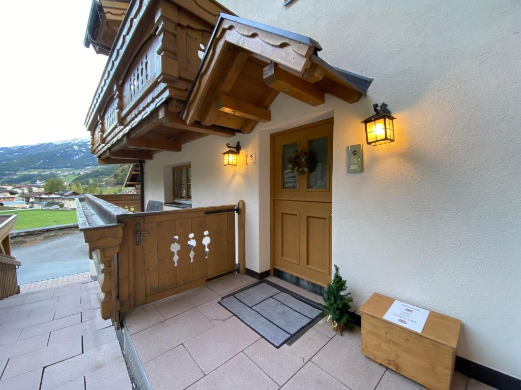 索尔登Alpine Lodge Sölden - Chalet & Apart的一座带木门和阳台的房子