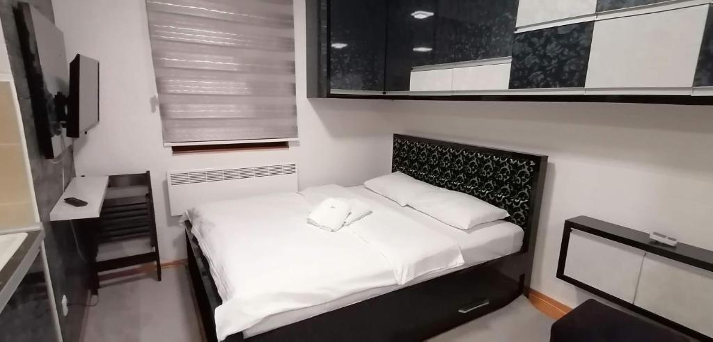 兹拉蒂博尔Apartman De lux Zlatibor的一间小卧室,房间内设有一张白色的床