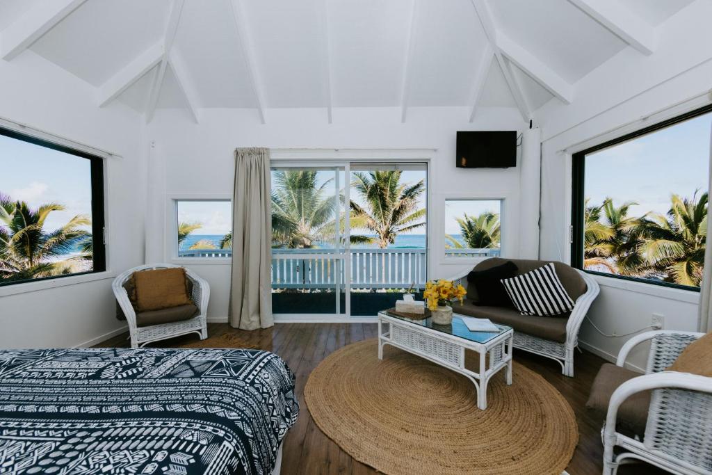 拉罗汤加The Passage Villas的一间卧室配有一张床、一张沙发和一张桌子