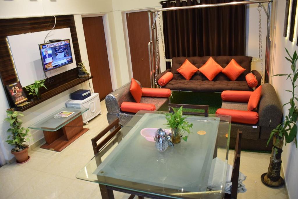 阿伯来Premium 2 BHK Green Suites的客厅配有沙发和桌子
