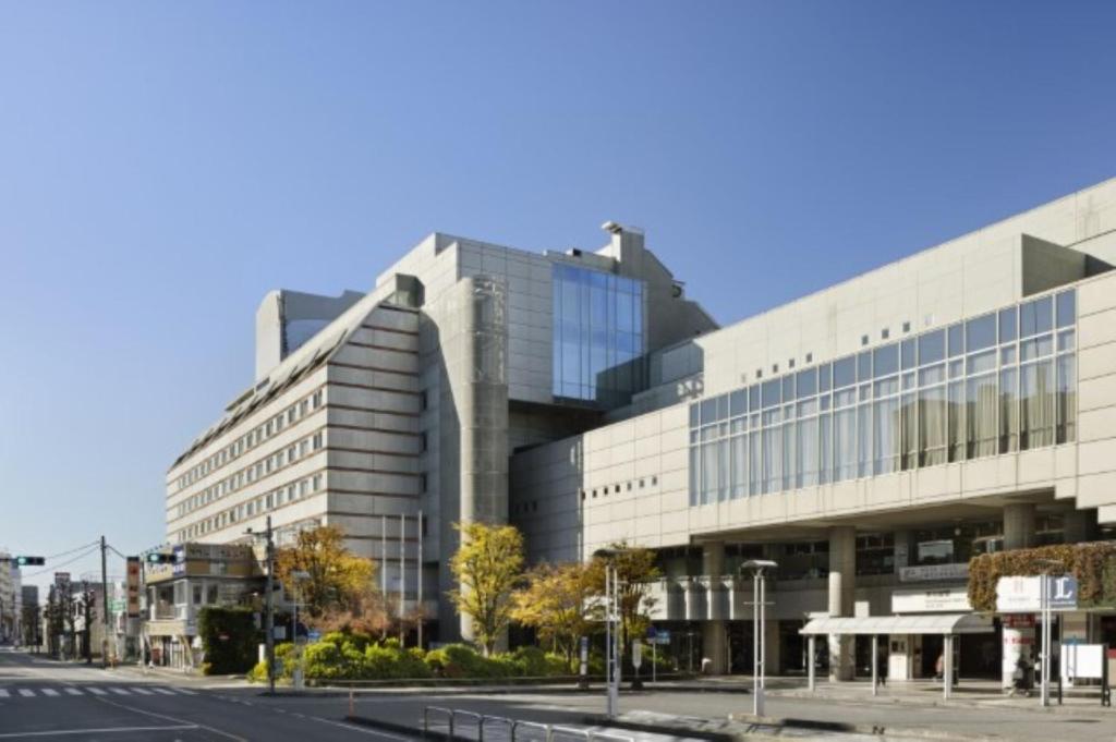 川越川越王子大饭店 的一条有道路的城市街道上的大型建筑