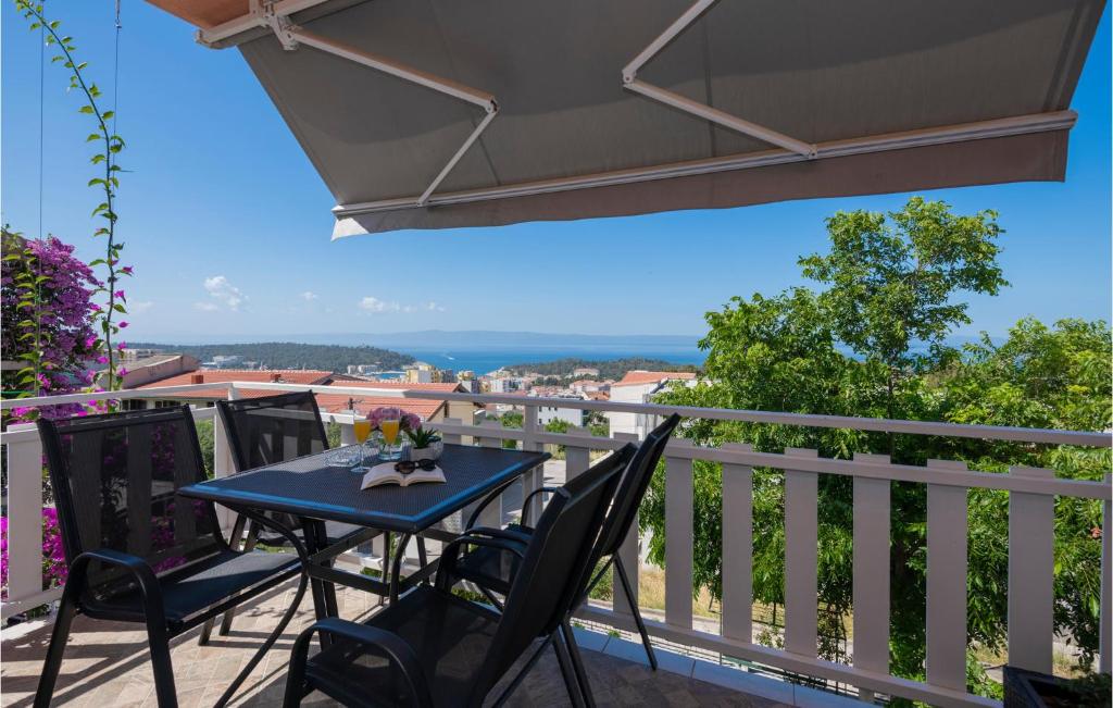 马卡尔斯卡Nice Apartment In Makarska With Kitchen的阳台上配有蓝色的桌椅