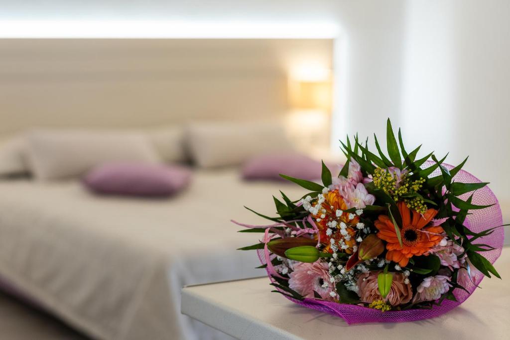 伊利索斯Terinikos Hotel Junior Suites & Apartments的卧室桌子上一束鲜花