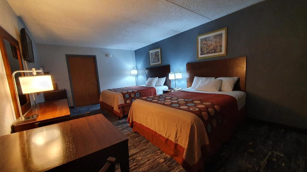 南帕诸岛South Padre Island Inn的有两张床和一张桌子的酒店房间
