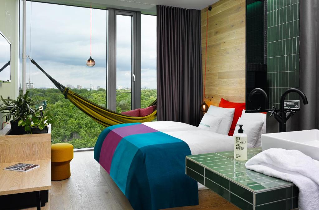 柏林柏林比基尼25小时酒店的一间卧室设有吊床和一张美景床。