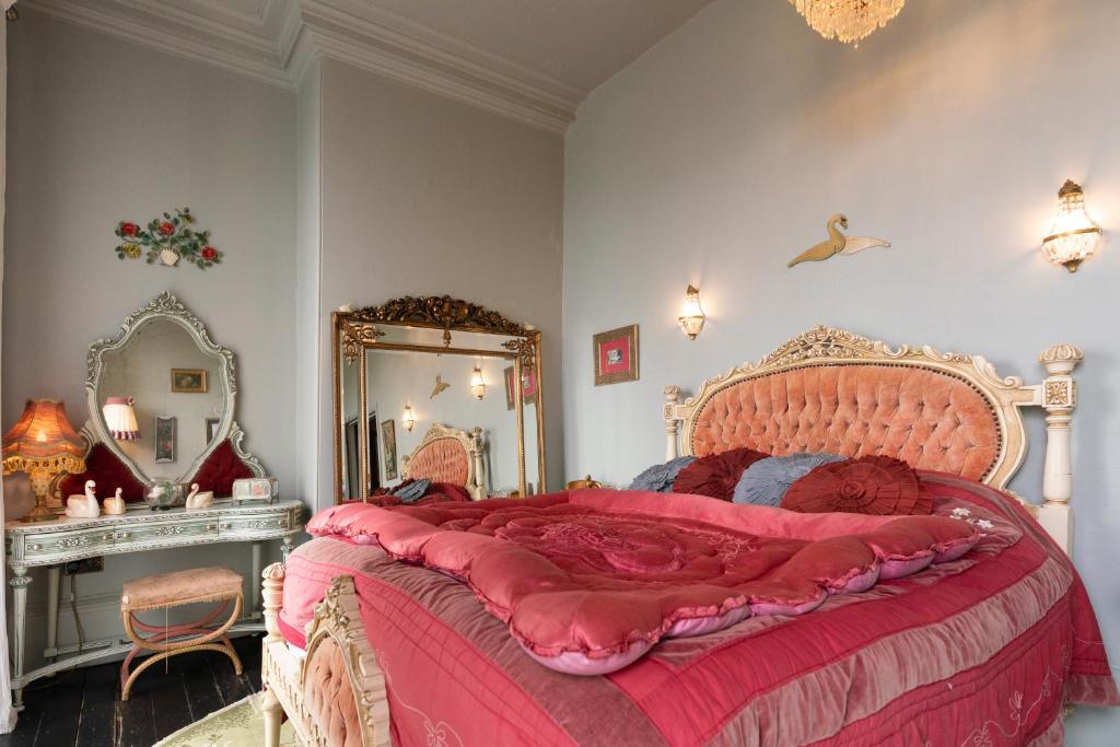 惠特比La Rosa Hotel的一间卧室配有一张大床和镜子