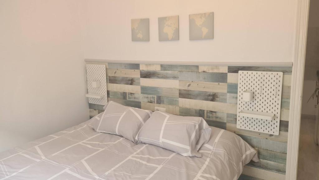 内尔哈艾尔巴里奥公寓酒店的一间卧室配有一张木墙床。