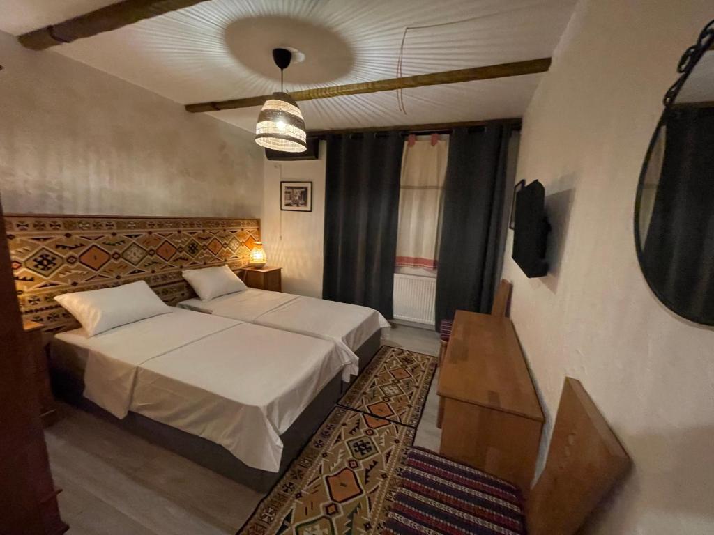 奥托佩尼Hotel Casa Romaneasca的卧室配有一张床和一张桌子