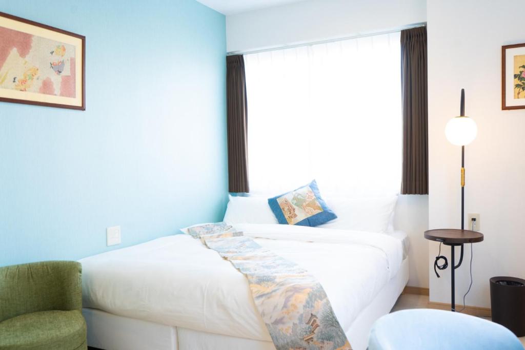 东京Kiba no Tsuru Carane Hotel - Vacation STAY 09997v的卧室配有白色的床和椅子