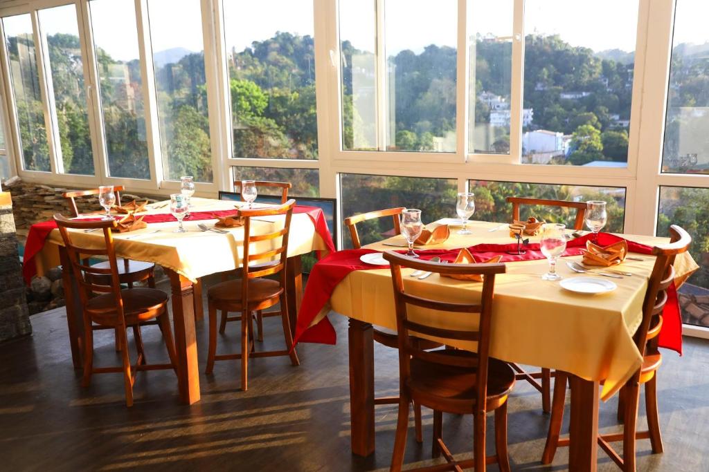 康提Crown & Crown Kandy的用餐室设有桌椅和窗户。