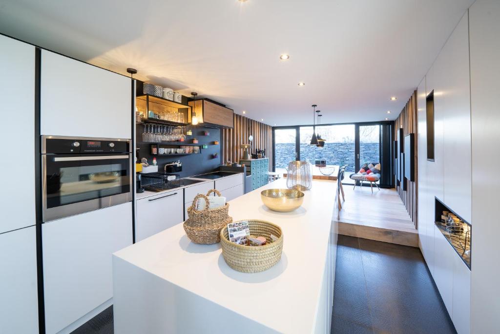 OnhayeGîtesdesignemoi entre Design et émotion - la perle的一间带白色台面的厨房和一间客厅