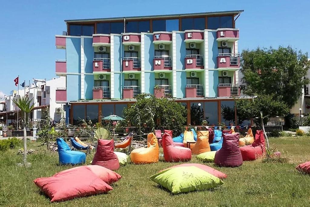 伊兹密尔Linda Butik Otel Gümüldür的一群五颜六色的枕头在一座建筑前面的草上