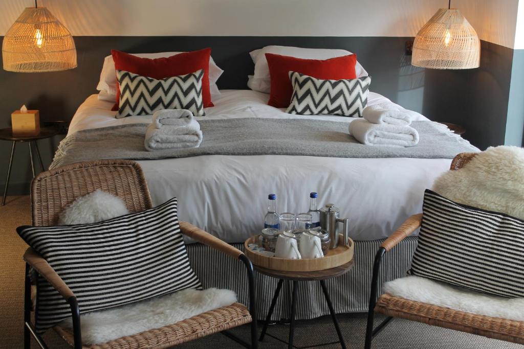 阿博因船屋旅馆的一间卧室配有一张大床和两把椅子