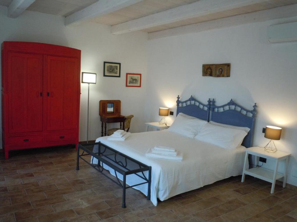 蒙基耶罗Antica Cascina Pilo的一间卧室配有一张大床和一个红色橱柜
