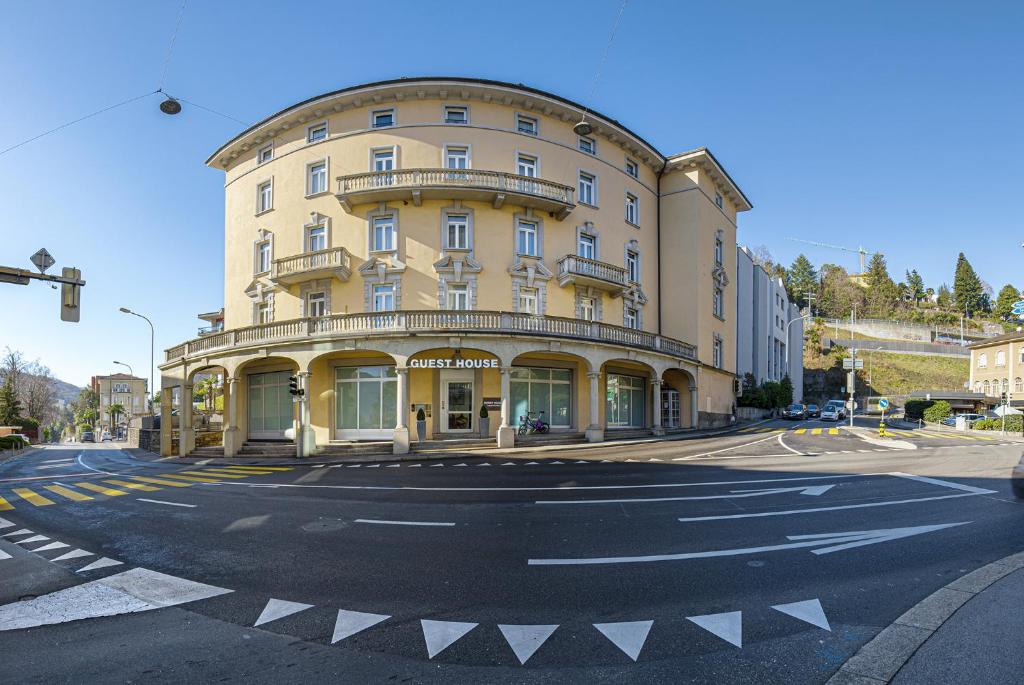 卢加诺GuestHouse Lugano Center by LR的街道拐角处的黄色大建筑