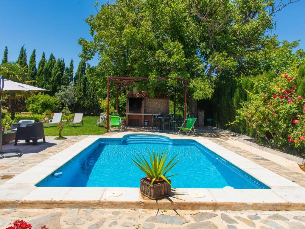 NigüelasHoliday Home Rincón del Sur by Interhome的庭院内的游泳池,配有桌椅