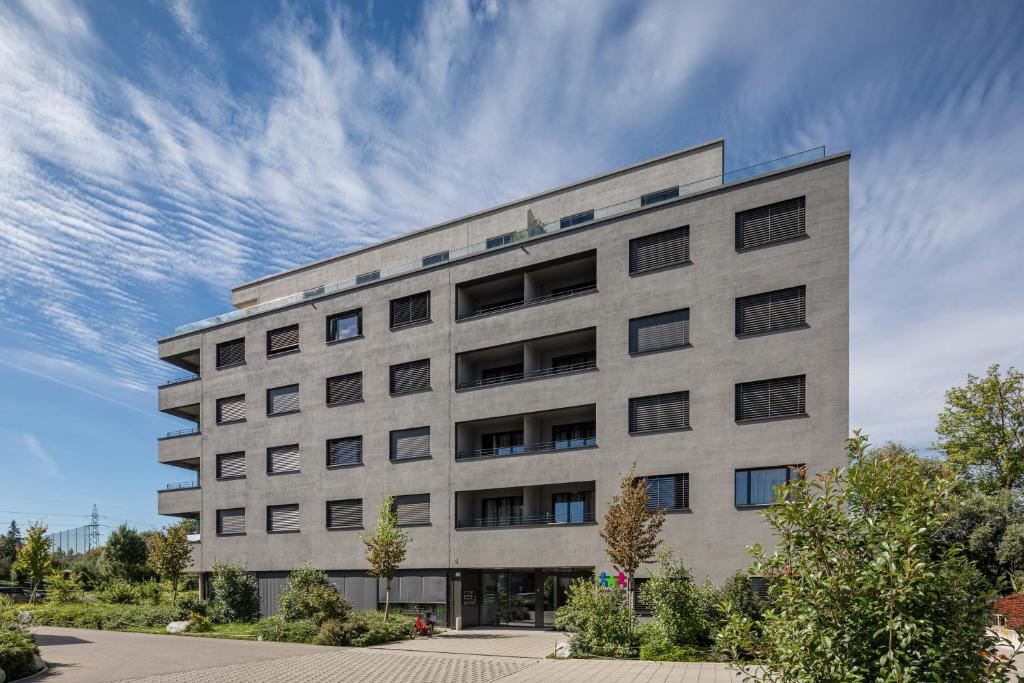 Oberentfelden阿劳韦斯特瑞士优质公寓式酒店的蓝色天空的大混凝土建筑