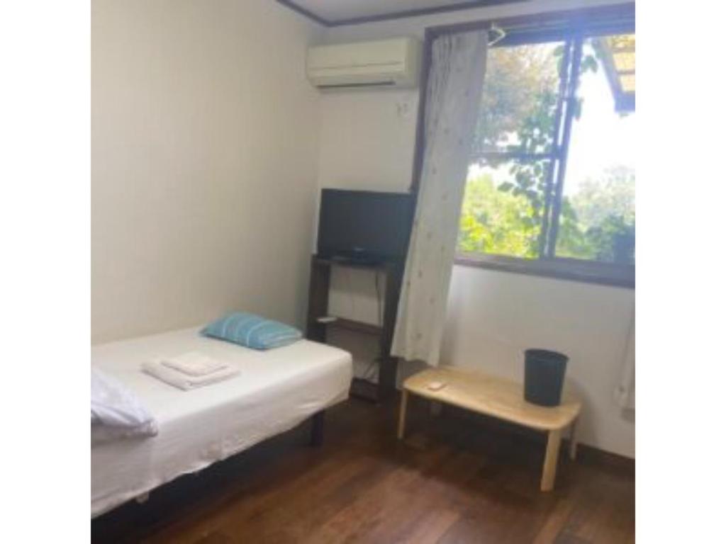 壹岐市Asobiyahouse Iki - Vacation STAY 30422v的小房间设有床和窗户
