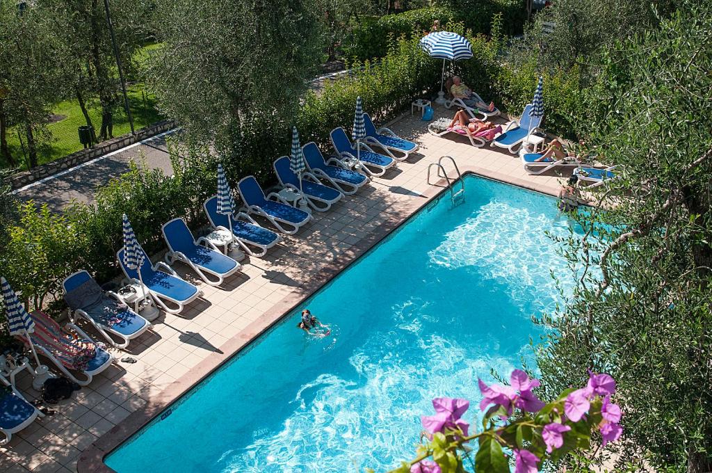利莫内-苏尔加达花园酒店的游泳池的顶部景色,设有躺椅和游泳者