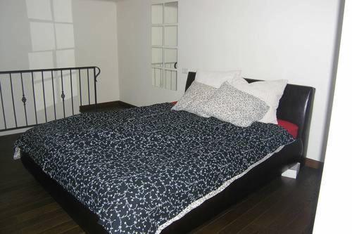 布达佩斯寿司公寓的卧室配有带枕头的黑白床。