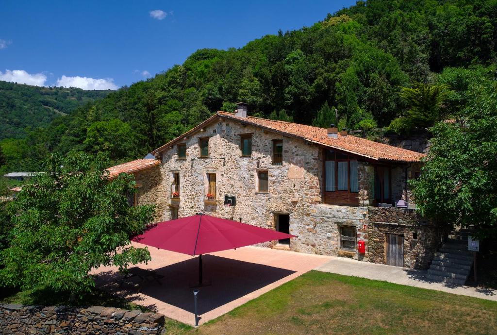 RocabrunaCasa Rural "Can Soler de Rocabruna" Camprodon的前面有红伞的房子