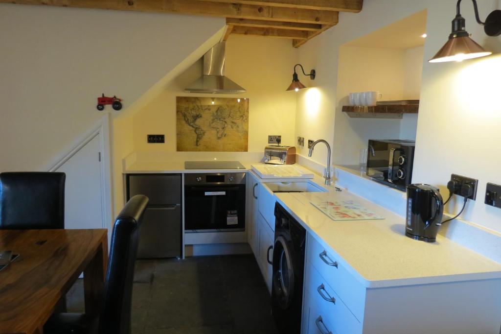 毕晓普奥克兰Farthing Cottage的厨房配有水槽和炉灶