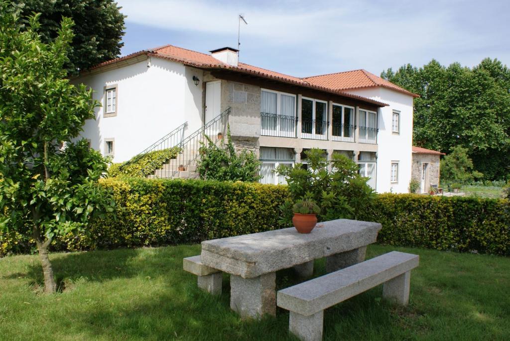 普拉多Quinta de São Bento的坐在房子前面的石凳