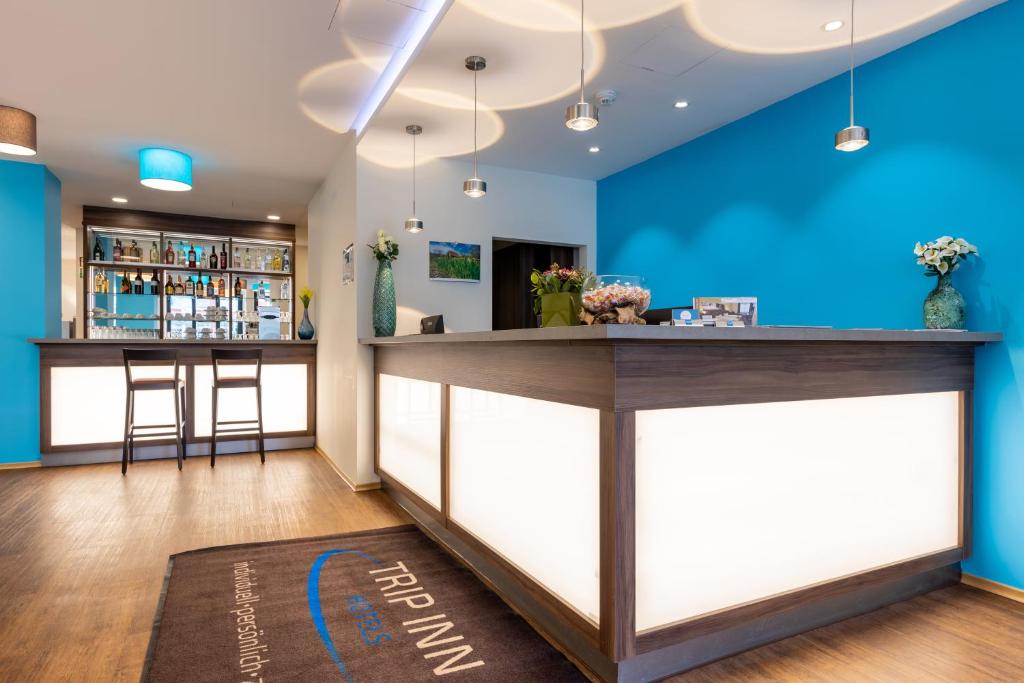明斯特Trip Inn Hotel Münster City的餐厅内拥有蓝色墙壁的酒吧