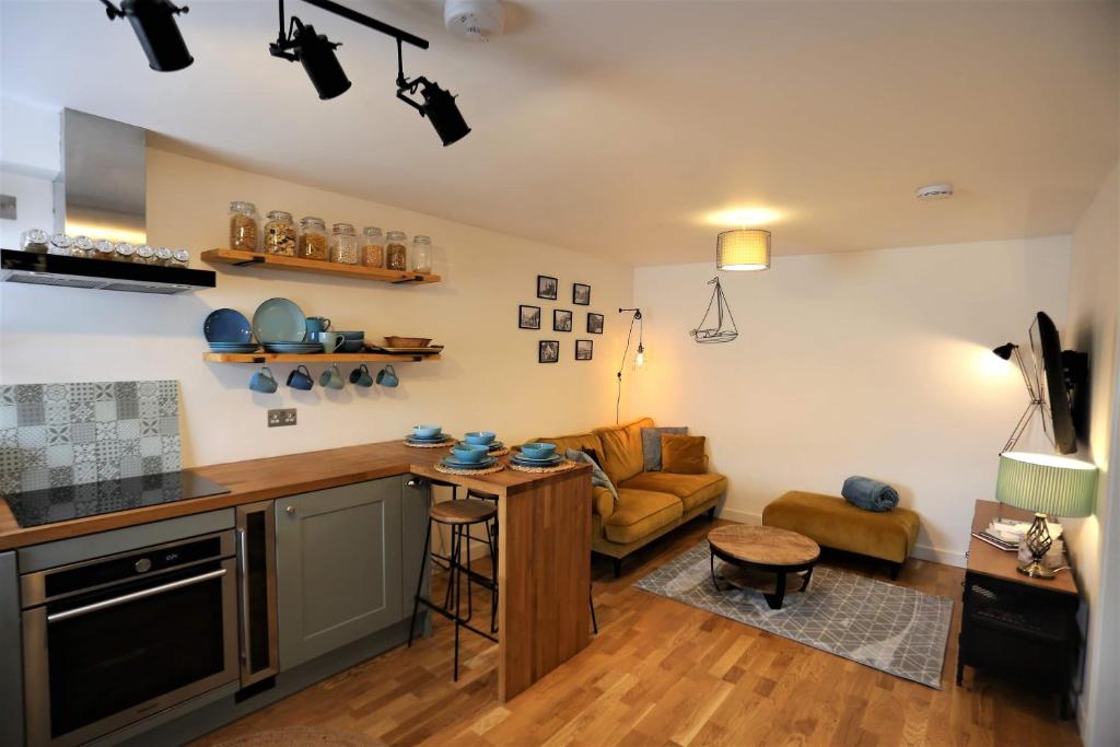 爱丁堡Old fisherman's Cottage No 4, free parking的厨房以及带沙发和桌子的客厅。